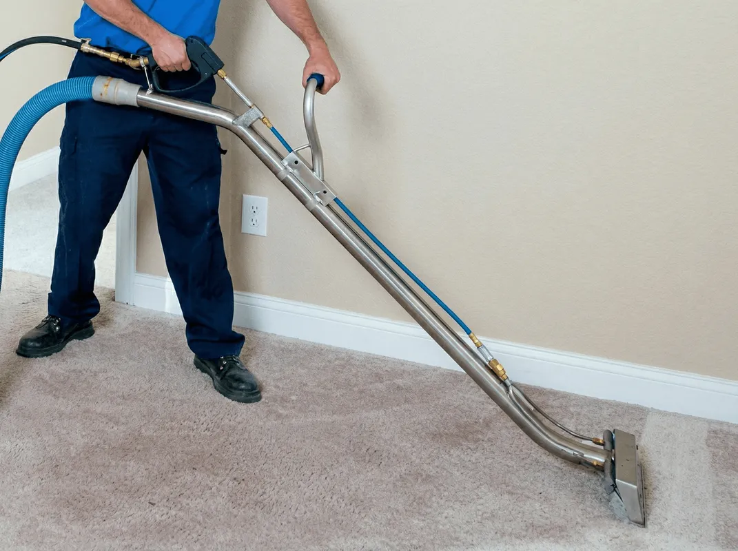 Professional operating a liquid removal machine on a carpeted floor in Honolulu, HI